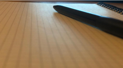 Ein leeres Blatt Papier, auf dem ein Kugelschreiber liegt.